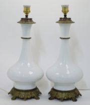 A pair of French gilt-brass-mounted celadon porcelain table lamps, 19th century, later converted ...