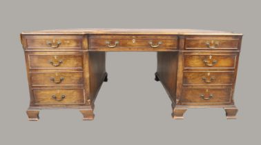 An English walnut inverted breakfront partners desk, of George II style, last quarter 19th centur...