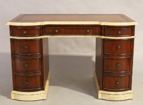 A modern mahogany kneehole desk, George III style, parcel cream painted, tooled leather writing s...
