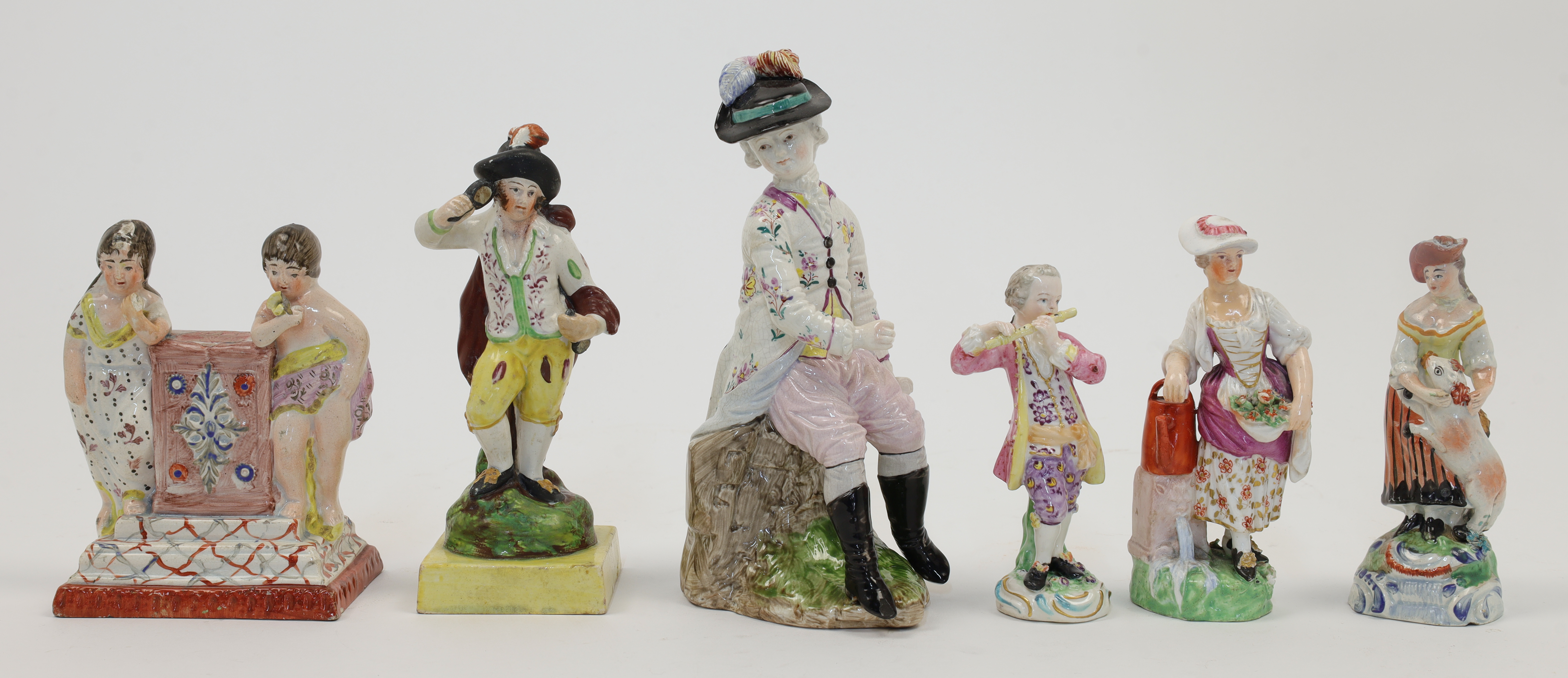 A group of English and Continental ceramic figures, 19th century, comprising: a Staffordshire pea...
