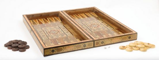 An inlaid parquetry backgammon board, 20th century, the hinged lid with metal clasp, with counter...