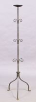An iron floor standing pricket candlestick, 20th century, with circular drip pan and three pairs ...