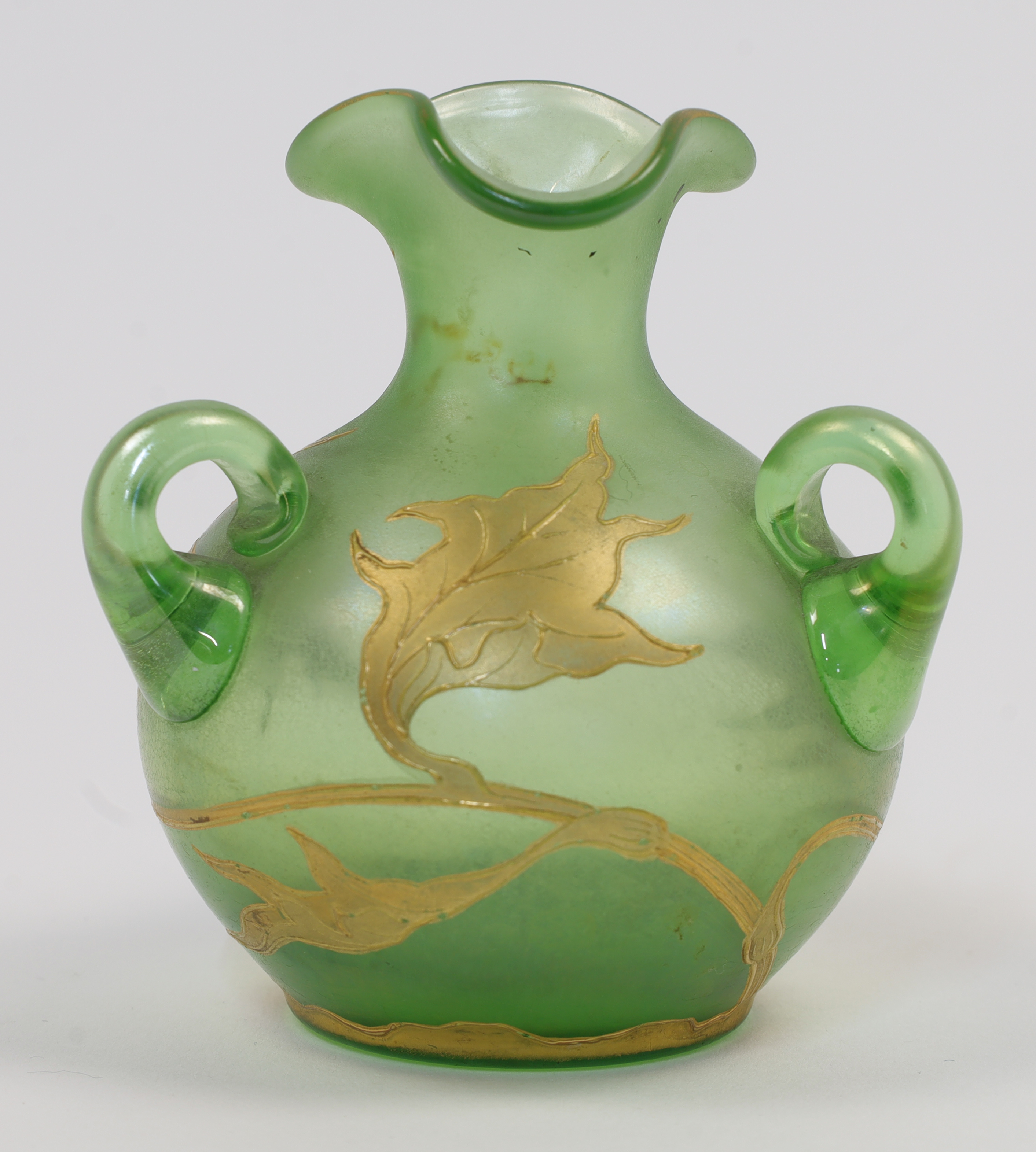 An Art Nouveau style green glass vase, 20th century, modelled with three handles and painted in g...