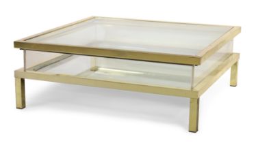 Attributed to Maison Jansen, a coffee table with sliding top, c.1970, lacquered brass, lucite, gl...