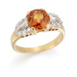 An orange sapphire and diamond ring, the round mixed cut orange sapphire to baguette and brillian...