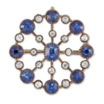 A sapphire and diamond circular brooch, a central oval mixed cut sapphire with radiating knife ed...