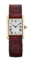 Cartier, London. An 18ct gold manual wind rectangular wristwatch with gold deployant clasp stampe...