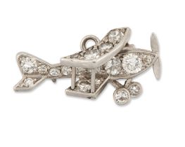 An early 20th century diamond set charm, in the form of a bi-plane, grain set with brilliant cut ...