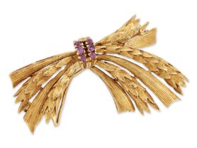 A ruby set spray brooch, with reeded and wheatsheaf textured sprays, gathered to a ruby set band,...