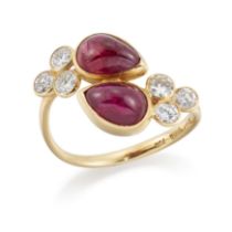 A ruby and diamond crossover ring, with a pair of pear shaped cabochon rubies each with a trefoil...