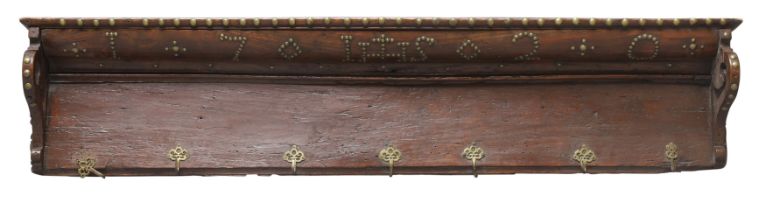 An English walnut clothes rack, first quarter 18th century, decorated in brass studs with the dat...