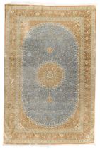 A Persian silk Qum carpet, last quarter 20th century, signed, the central floral medallion surrou...