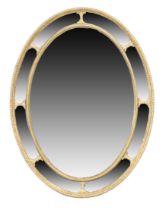 A George III carved giltwood oval mirror, last quarter 18th century, with marginal border, 85cm h...