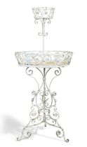 An Edwardian white-painted wrought iron revolving plant stand, early 20th century, with scroll an...