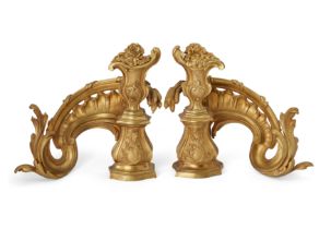A pair of French gilt-bronze chenets, of Louis XV style, early 20th century, each of pierced scro...