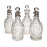 Two similar pairs of George III lead crystal decanters and stoppers, late 18th / early 19th centu...