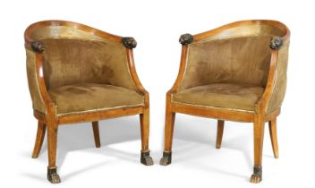 A pair of brass-mounted Empire mahogany tub chairs, first quarter 19th century, with lion head ar...