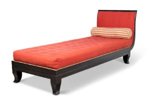 An Anglo-Indian ebony daybed, first half 20th century, with red-covered seat cushion and back; to...