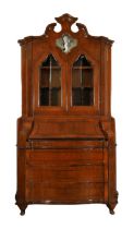 An Italian walnut bureau bookcase, third quarter 18th century, the shaped pediment above cartouch...