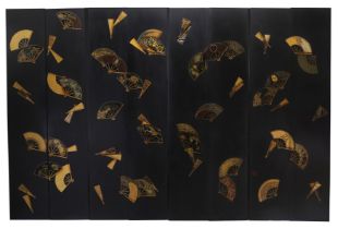 A large black painted eight panel folding room screen, designed by Nicky Haslam, c.1970s, gilt de...