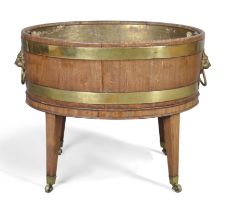 An English brass bound mahogany oval wine cooler, of George III style, 19th century, with brass l...