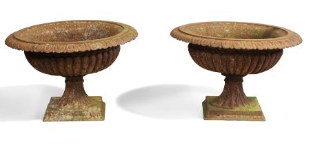 A pair of French cast-iron urns, late 19th century, each with egg and dart rim above lobed bodies...