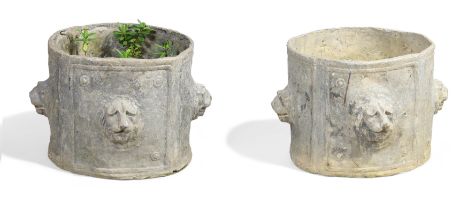 A pair of cylindrical lead planters, 20th century, cast with lion mask reliefs, 26cm high, 37cm d...