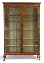 An English red lacquered and japanned bookcase, first quarter 20th century, the stepped cornice a...