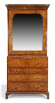 A George II walnut cabinet on secretaire chest, second quarter 18th century, feather banded, the ...