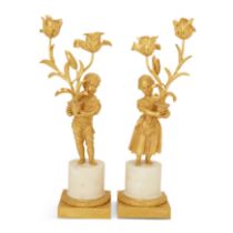 A pair of late Louis XVI ormolu twin-light figural candelabra, late 18th century, each modelled a...