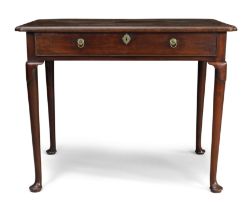 A George II walnut side table, second quarter 18th century, the rectangular top with shaped corne...
