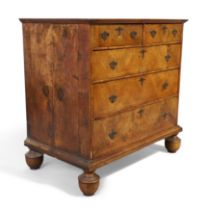 A Queen Anne inlaid walnut chest, first quarter 18th century, with two short over three long grad...