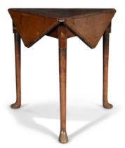 A George II walnut hexagonal drop leaf table, second quarter 18th century, the revolving top on t...