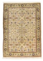A Turkish silk Hereke rug, third quarter 20th century, signed, the central field with floral swag...
