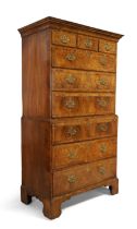 A George II walnut chest on chest, second quarter 18th century, crossbanded and feather banded, w...