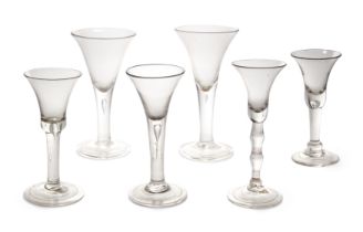 A group of six Georgian wine glasses, mid-18th century, five with plain teardrop stems, comprisin...