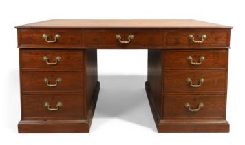 A George III mahogany partners desk, last quarter 18th century, the tooled leather top above an a...