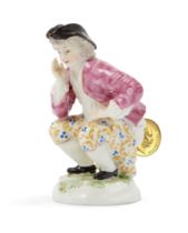 A Continental porcelain 'Dukatenscheisser' figure, 19th century, or perhaps earlier, puce D mark,...