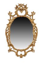 A George III giltwood mirror, last quarter 18th century, the carved frame with C-scrolls and rose...