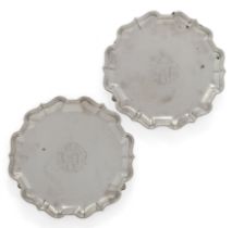 A pair of George II Britannia silver waiters.  Francis Nelme,  London, 1734.  Of shaped, circu...