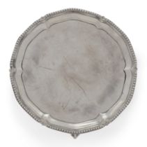 A George III silver waiter.  Maker IC,  London, 1776.  Of shaped, circular form, with beaded r...