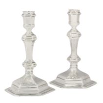 A pair of George I Britannia silver cast candlesticks.  Maker's mark 'Co' in shield-shaped punch...