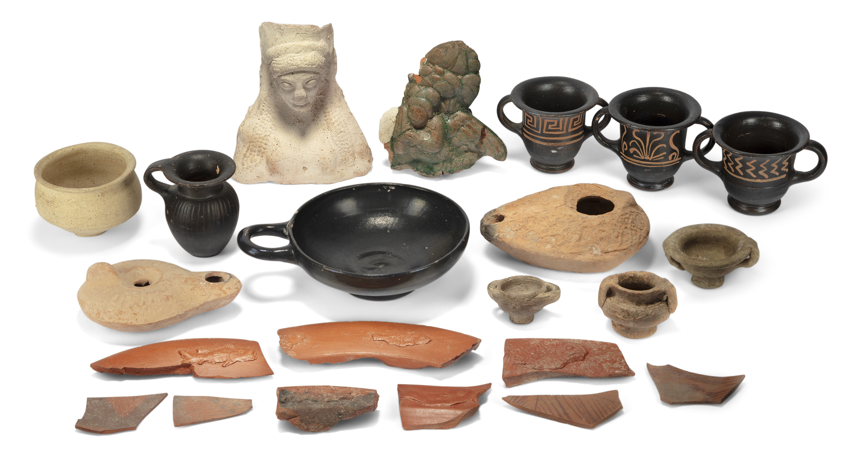 A group of terracotta items including three Xenon ware cups, A Greek black-glazed miniature vesse...