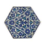 An Iznik hexagonal pottery tile, Ottoman Turkey, 1520-30, Decorated with a radial design of pal...