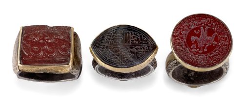 Three Safavid, Timurid and Qajar hardstone inscribed seals, Iran, 18th-19th century, mounted as...