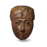 An Egyptian polychrome painted wood coffin mask, Third Intermediate Period, circa 1069-715 B.C.,...