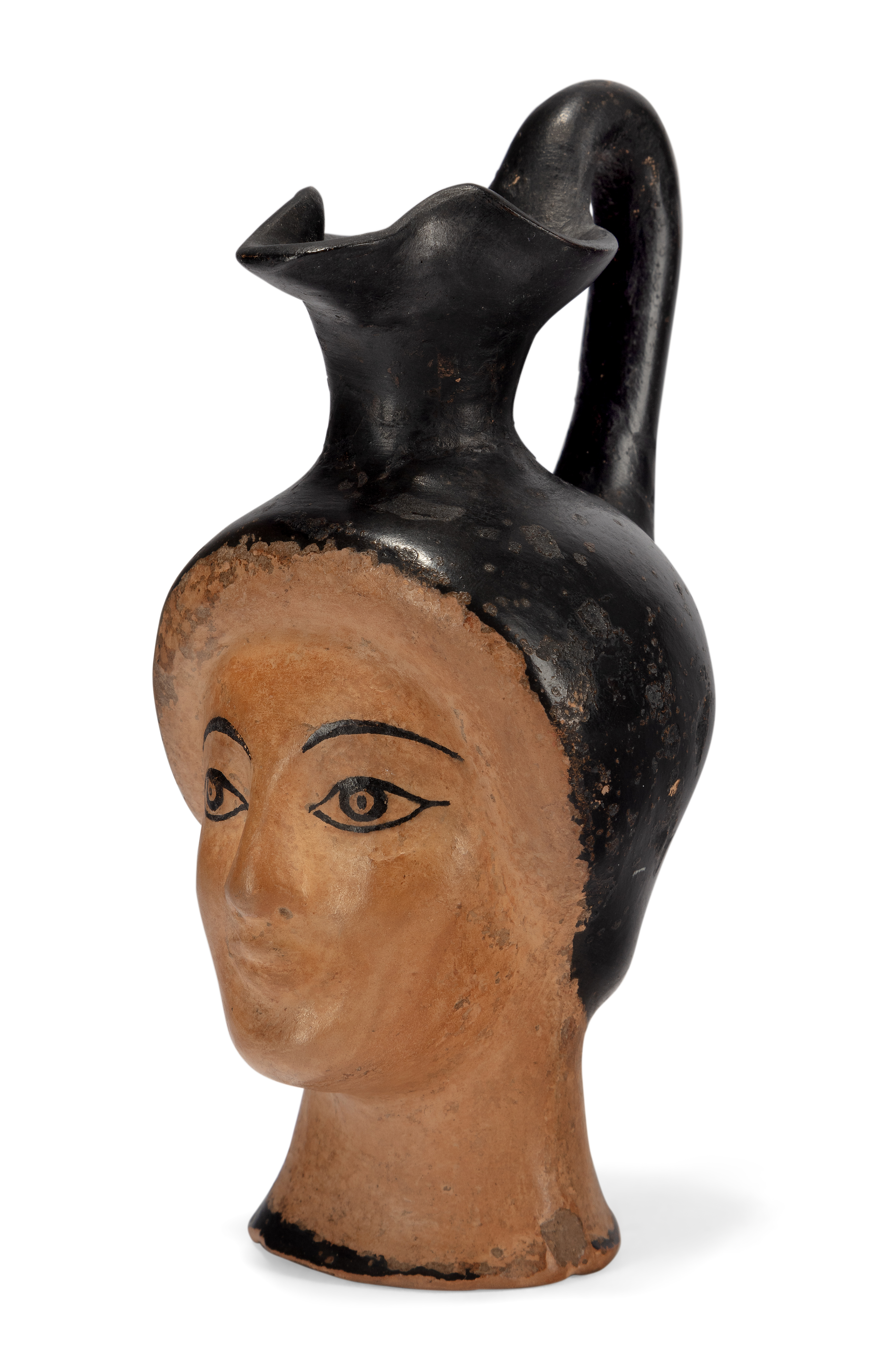 An Attic "head" oinochoe, circa 500-450 B.C.  In the form of a female head with finely painted ...