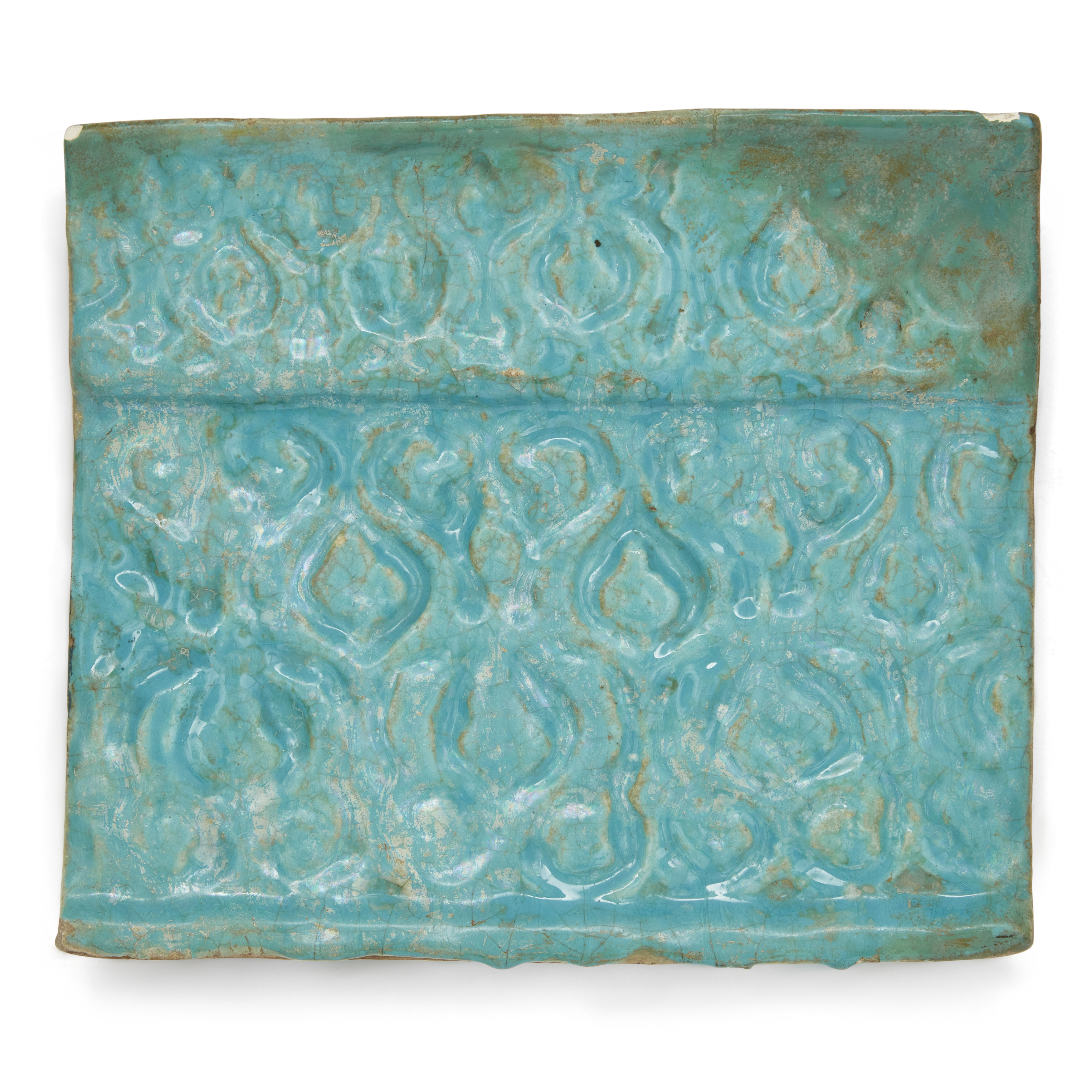 To Be Sold With No Reserve A rectangular turquoise glazed moulded pottery tile, Kashan, Iran, 1...