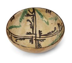 A shallow splashware pottery bowl Nishapur, Northeast Iran, 10th century On short straight foot...