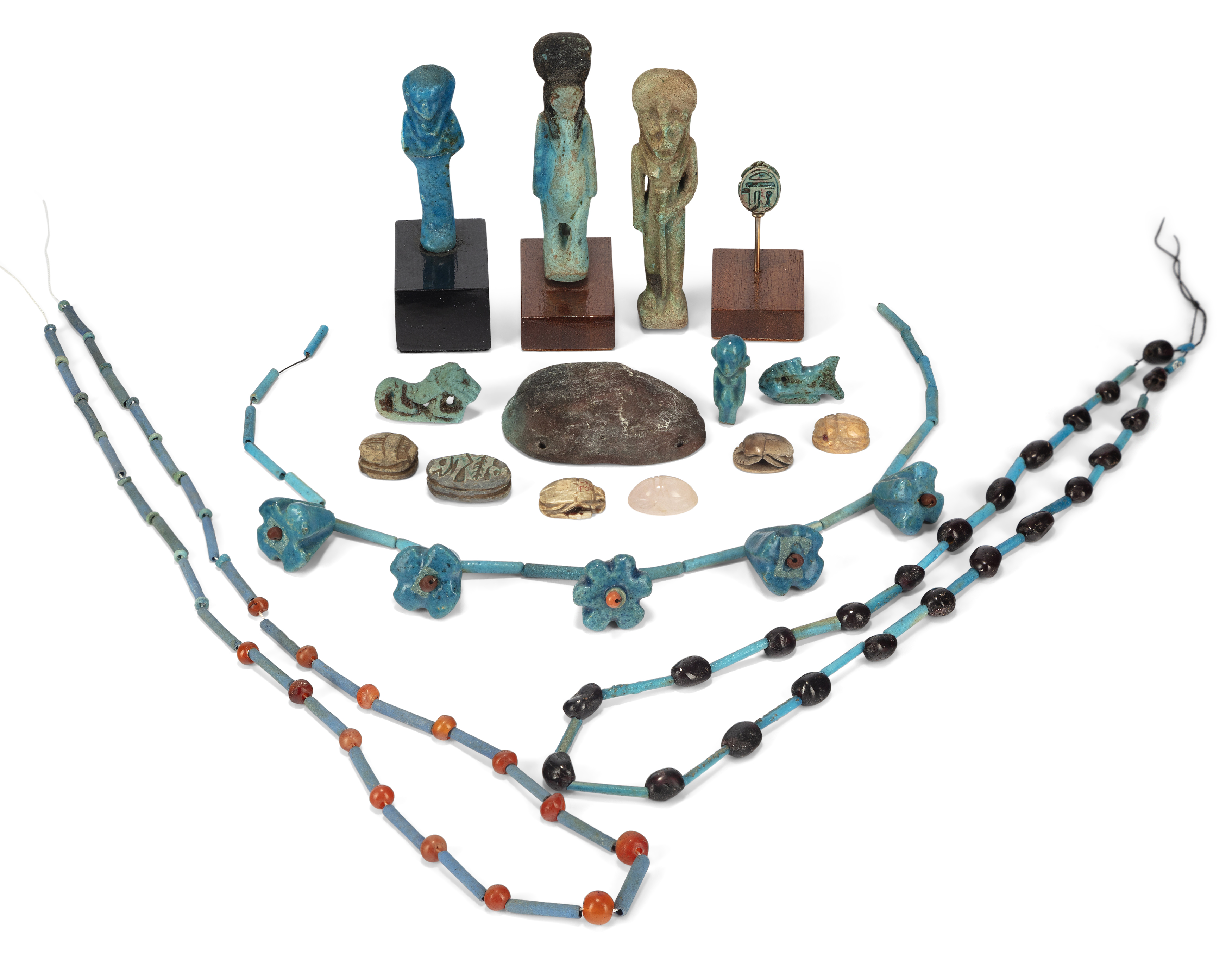 A miscellaneous group of Egyptian style objects Including carnelian, faience and Egyptian Blue b...